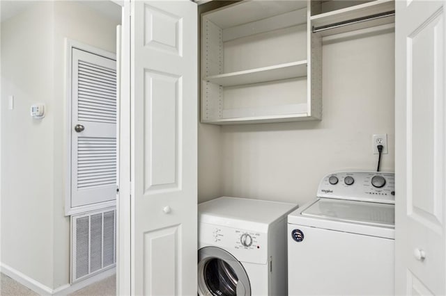 laundry area with laundry area, visible vents, independent washer and dryer, and baseboards