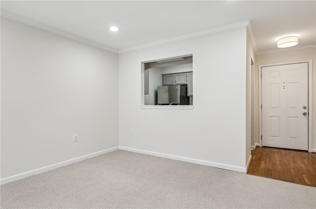 carpeted empty room with ornamental molding, recessed lighting, and baseboards