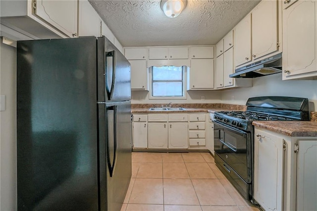 kitchen featuring white cabinetry, sink, light tile patterned floors, and black appliances