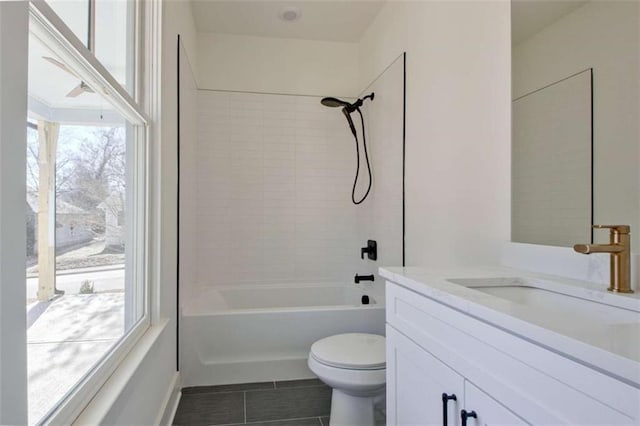 full bathroom with vanity, tile patterned flooring, tiled shower / bath combo, and toilet