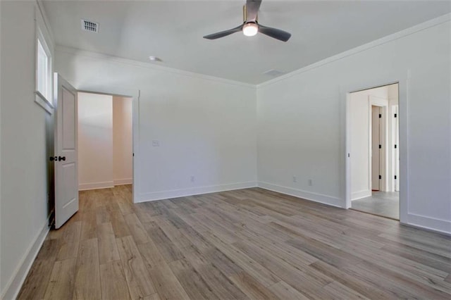 spare room featuring ornamental molding, ceiling fan, and light hardwood / wood-style floors