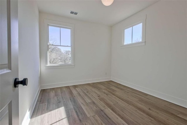 spare room with light hardwood / wood-style floors