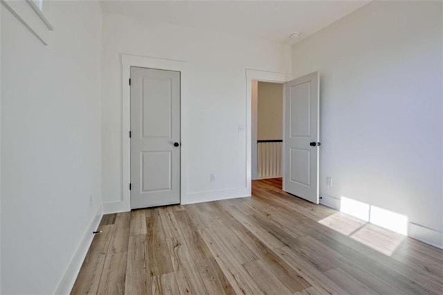 unfurnished bedroom featuring light wood-type flooring