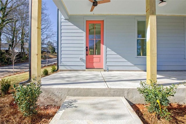 entrance to property with ceiling fan and a porch