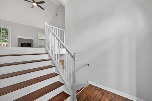 563 Bailey Dr, Jefferson, GA 30549 - staircase with wood finished floors, ceiling fan, high vaulted ceiling, and a fireplace