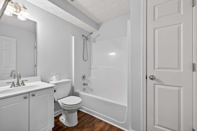 563 Bailey Dr, Jefferson, GA 30549 - full bathroom with vanity, wood finished floors, shower / washtub combination, and a textured ceiling