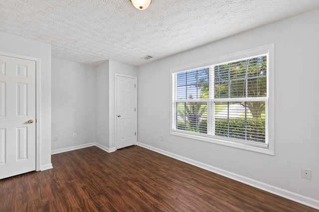 563 Bailey Dr, Jefferson, GA 30549 - spare room with dark wood-style flooring and a textured ceiling
