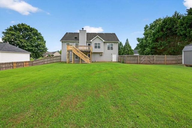 563 Bailey Dr, Jefferson, GA 30549 - rear view of house featuring stairs, a fenced backyard, a chimney, a deck, and a storage shed