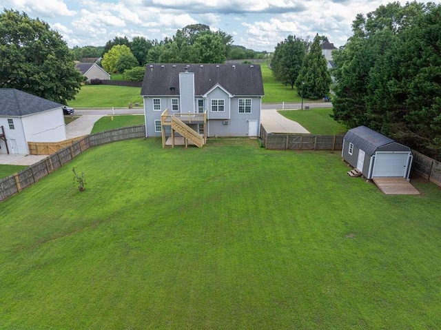 563 Bailey Dr, Jefferson, GA 30549 - back of property with stairway, an outbuilding, a fenced backyard, a detached garage, and a chimney