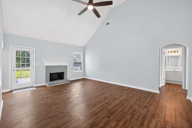 563 Bailey Dr, Jefferson, GA 30549 - unfurnished living room with high vaulted ceiling, a ceiling fan, a brick fireplace, dark wood-style floors, and arched walkways