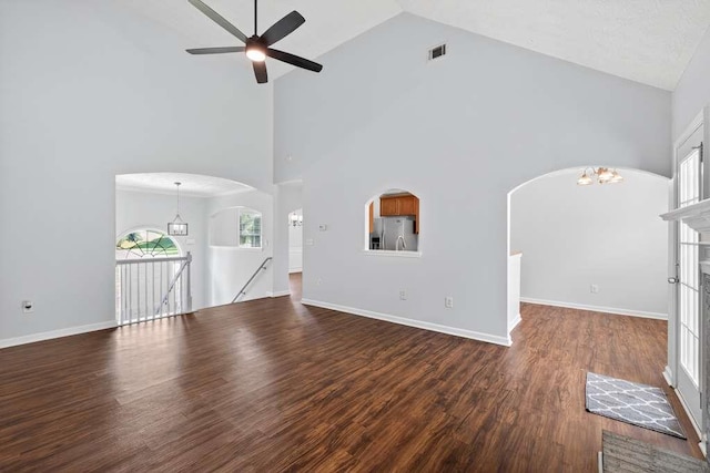 563 Bailey Dr, Jefferson, GA 30549 - unfurnished living room featuring high vaulted ceiling, a ceiling fan, a chandelier, wood finished floors, and arched walkways