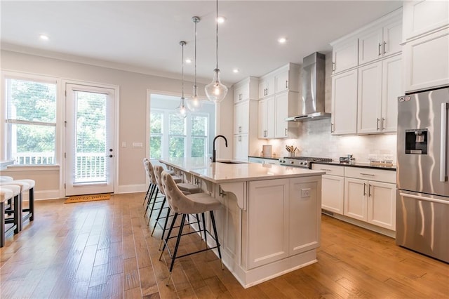 1964 Attell Way, Decatur, GA 30033 - kitchen with stainless steel refrigerator with ice dispenser, wall chimney range hood, a sink, a center island with sink, and tasteful backsplash