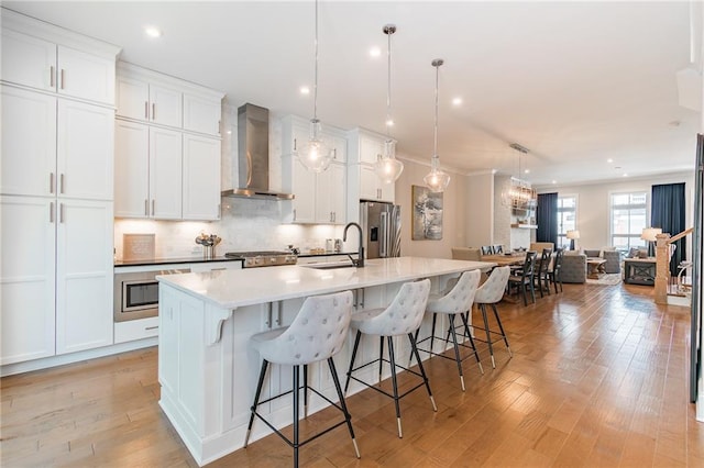 1964 Attell Way, Decatur, GA 30033 - kitchen with wall chimney exhaust hood, stainless steel refrigerator with ice dispenser, a spacious island, white cabinetry, and recessed lighting