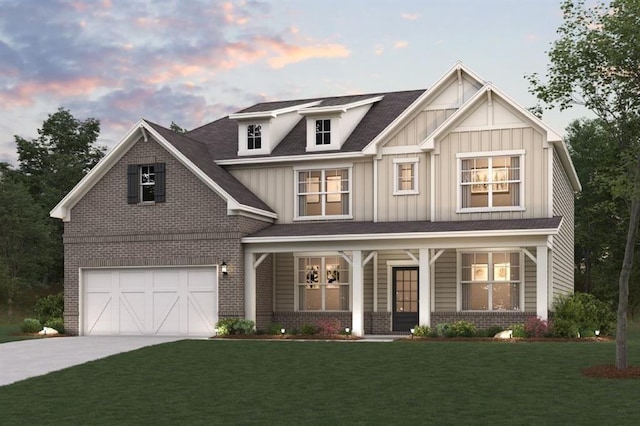 view of front of property with a garage, a lawn, and a porch