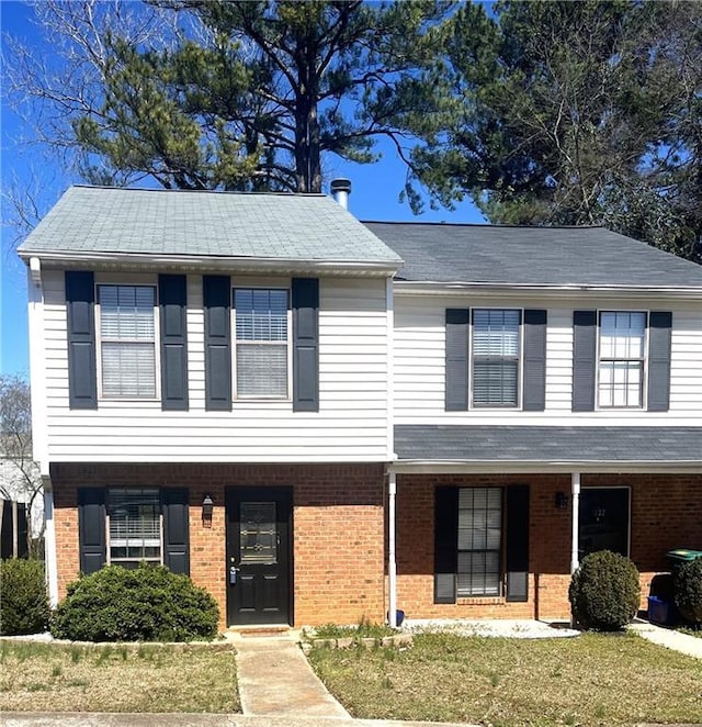 view of front of property with brick siding and a front lawn