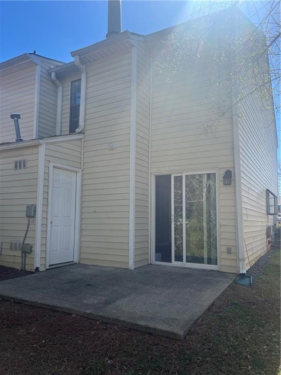 rear view of property featuring a patio area