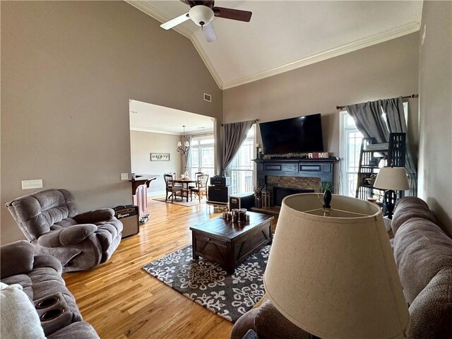 dining room with visible vents, wood finished floors, an inviting chandelier, crown molding, and baseboards