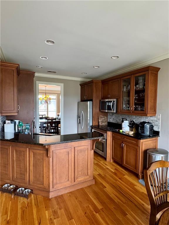 entrance foyer featuring visible vents, light wood-type flooring, and baseboards