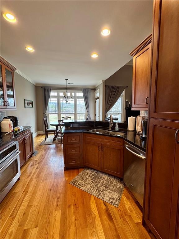 dining area featuring visible vents, crown molding, baseboards, wood finished floors, and a notable chandelier