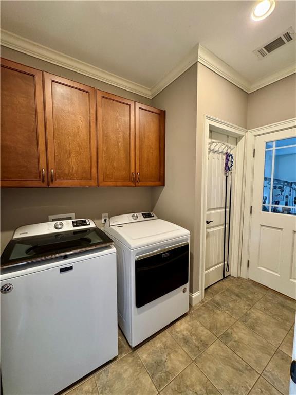 bathroom featuring a sink, a garden tub, crown molding, and tile patterned flooring