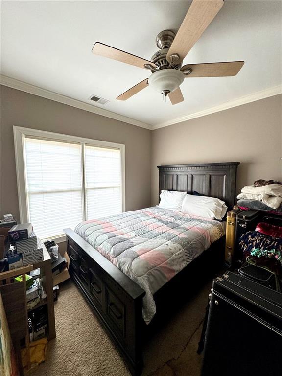 washroom featuring visible vents, light tile patterned flooring, cabinet space, crown molding, and washing machine and dryer