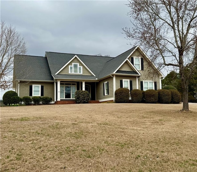 craftsman inspired home with a front lawn