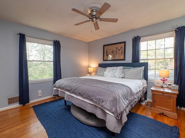 bedroom featuring ceiling fan, vaulted ceiling, and light hardwood / wood-style flooring