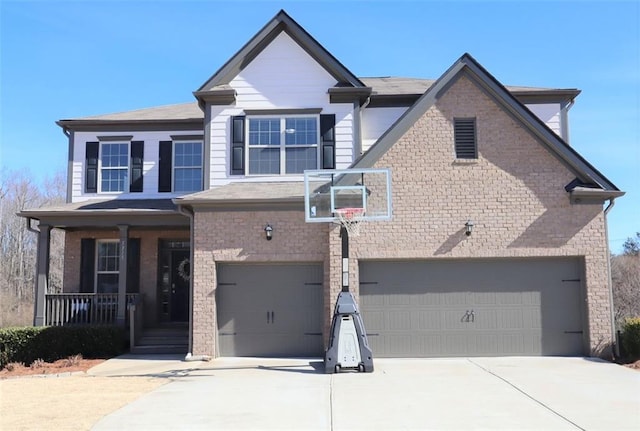 view of front of property with an attached garage, a porch, concrete driveway, and brick siding