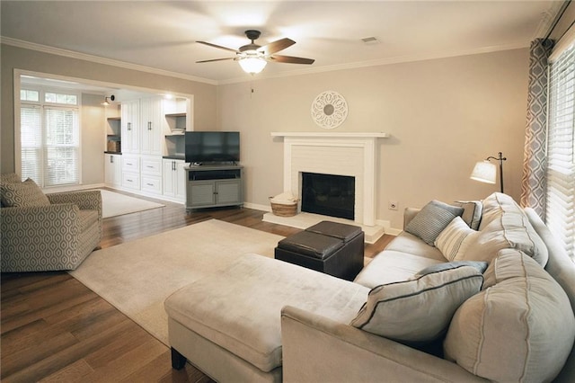 4130 Providnce Sq, Alpharetta, GA 30009 - living area with a ceiling fan, dark wood-type flooring, crown molding, a fireplace with raised hearth, and baseboards