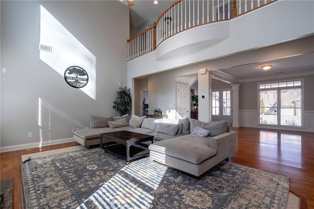 living room featuring hardwood / wood-style flooring and ornamental molding