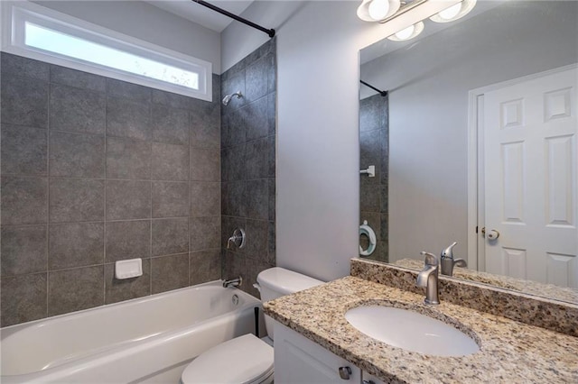 full bathroom featuring vanity, toilet, and tiled shower / bath