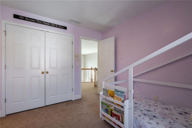 unfurnished bedroom with a closet and light carpet