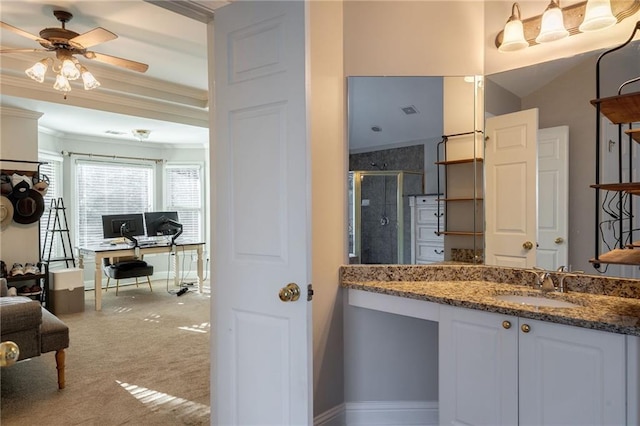 bathroom with an enclosed shower, vanity, ornamental molding, and ceiling fan