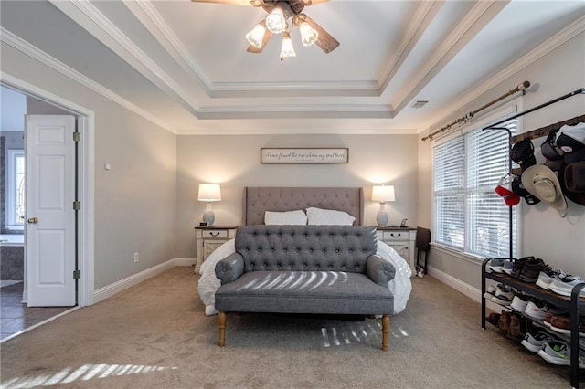 carpeted bedroom with a raised ceiling and ornamental molding