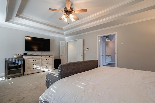 bedroom with a raised ceiling, ornamental molding, carpet, and ceiling fan