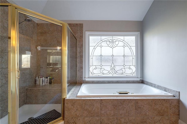 bathroom featuring independent shower and bath and lofted ceiling