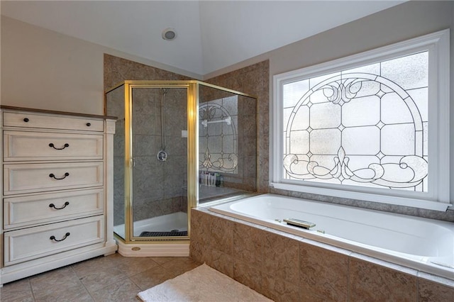 bathroom with shower with separate bathtub, tile patterned flooring, and vaulted ceiling