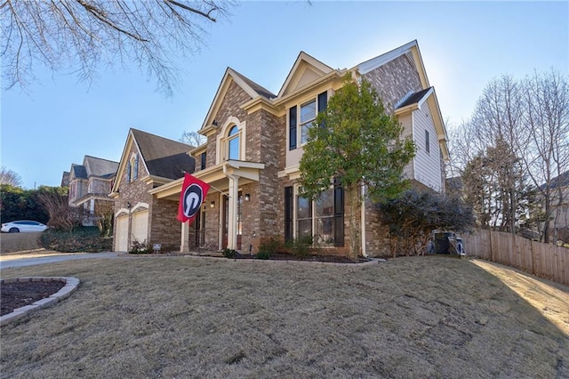 view of property with a garage and a front lawn