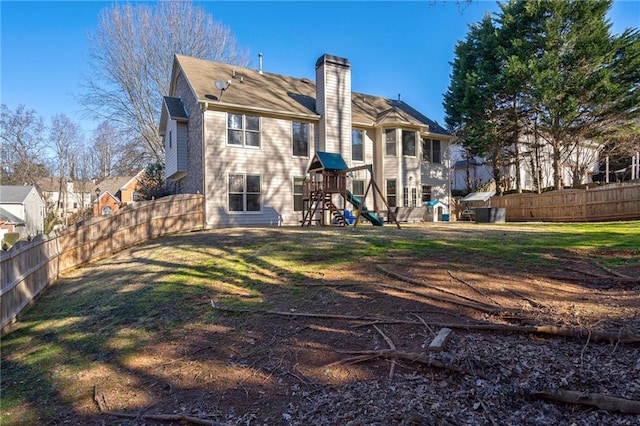 back of property with a playground