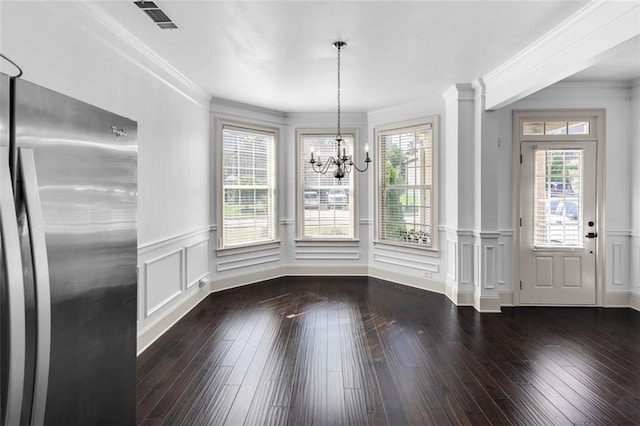908 Rainsong Ct, Braselton, GA 30517 - unfurnished dining area featuring healthy amount of natural light, a chandelier, crown molding, a decorative wall, and wainscoting