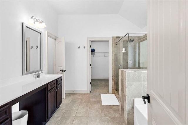 908 Rainsong Ct, Braselton, GA 30517 - bathroom featuring a shower stall, a bath, vanity, a spacious closet, and lofted ceiling