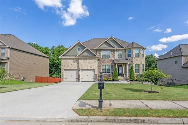 908 Rainsong Ct, Braselton, GA 30517 - craftsman-style home with driveway, an attached garage, and brick siding