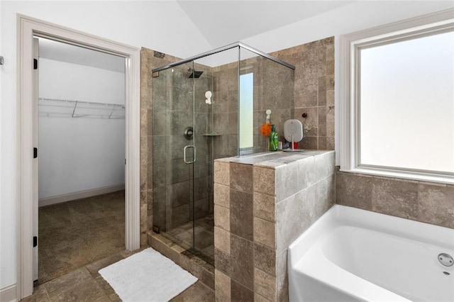 908 Rainsong Ct, Braselton, GA 30517 - full bathroom featuring a garden tub, a stall shower, a spacious closet, and vaulted ceiling