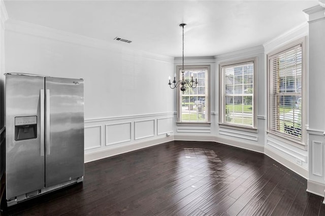 908 Rainsong Ct, Braselton, GA 30517 - unfurnished dining area with ornamental molding, a chandelier, healthy amount of natural light, dark wood finished floors, and wainscoting