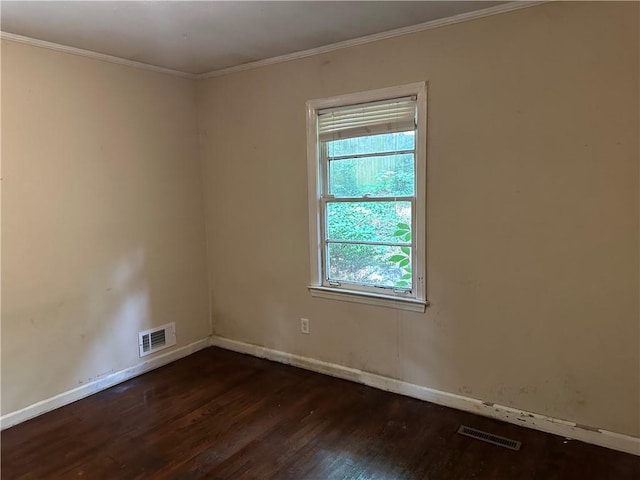 spare room with dark wood-style floors, baseboards, and crown molding