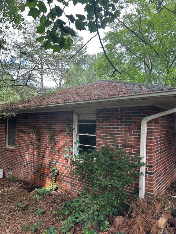 view of side of property featuring brick siding