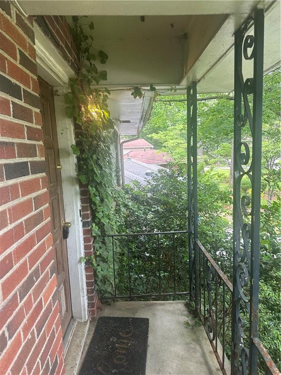 doorway to property featuring brick siding