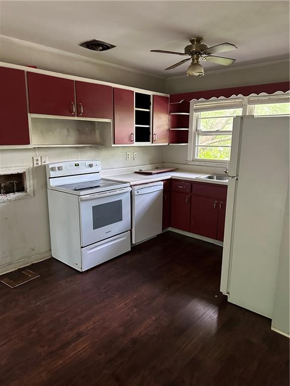 kitchen with white appliances, open shelves, red cabinets, dark wood-type flooring, and light countertops
