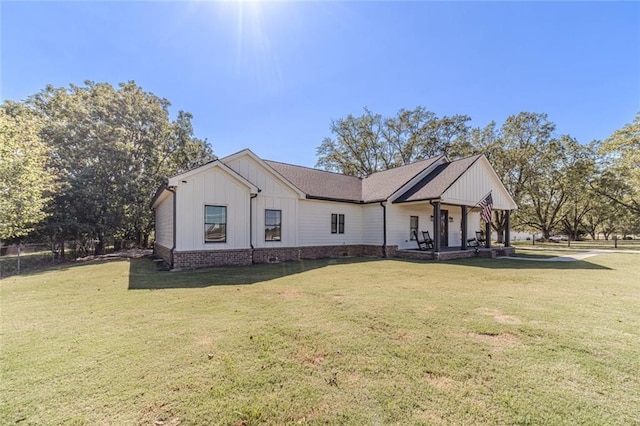 modern farmhouse style home featuring a front lawn and board and batten siding