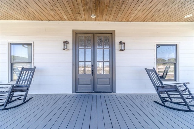 entrance to property featuring a porch and french doors